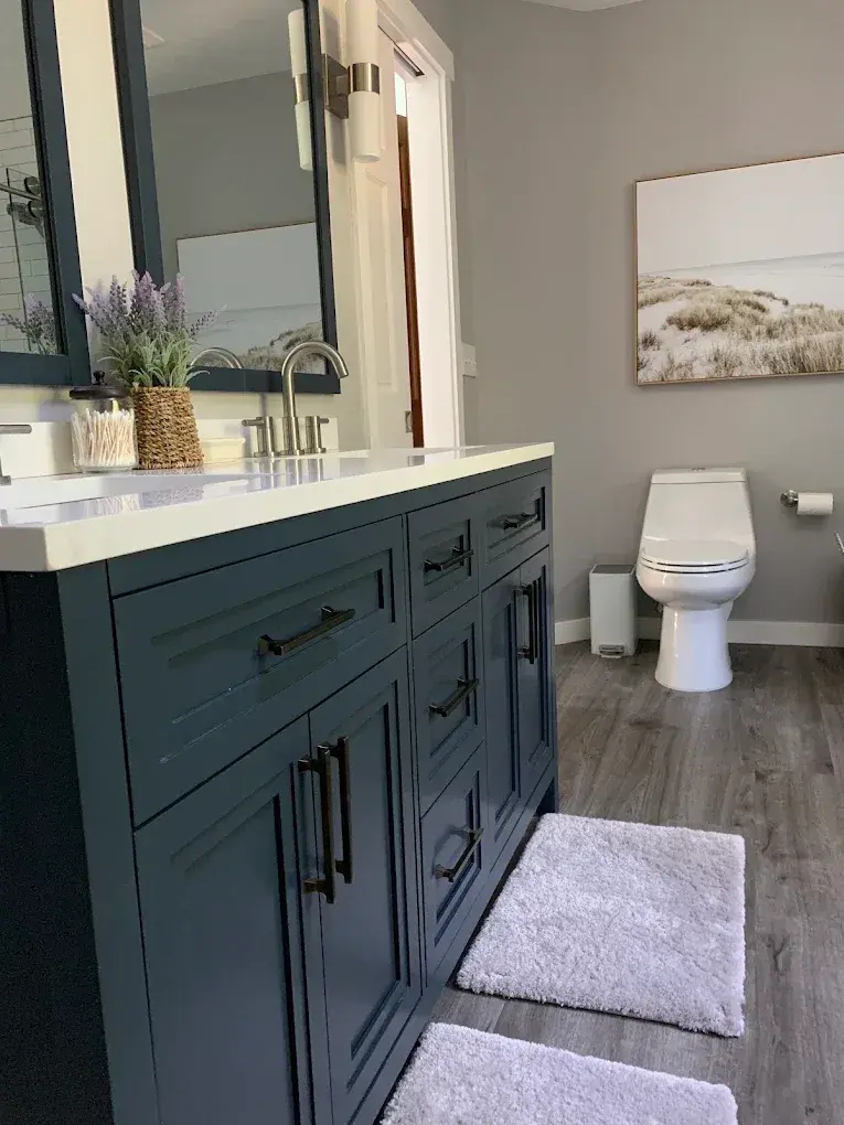 Bathroom with a navy double vanity and quartz countertop