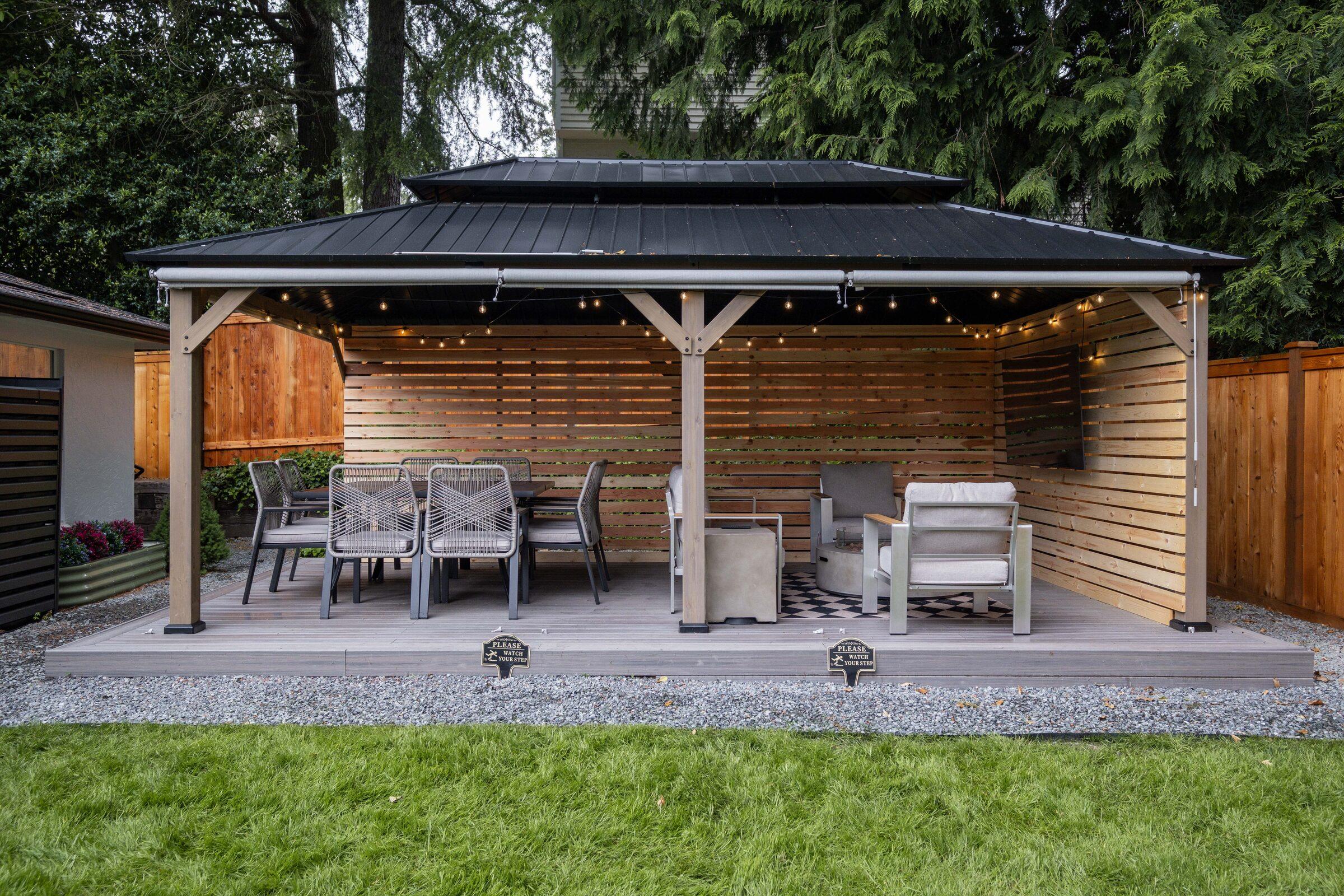 Long modern home exterior with a fenced lawn