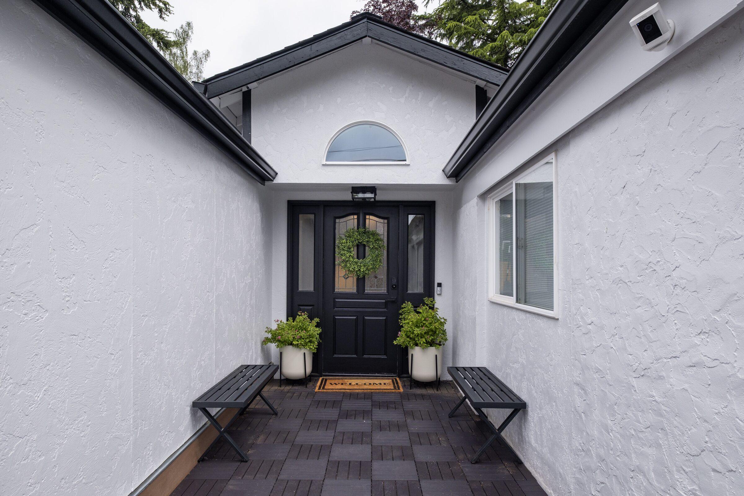 Home front entry with an arched dark door